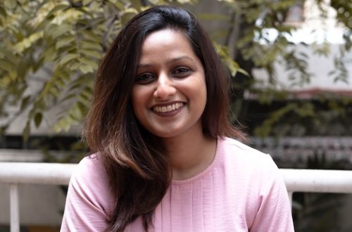 Female strategist at her desk, representing masculine energy at work and corporate burnout culture