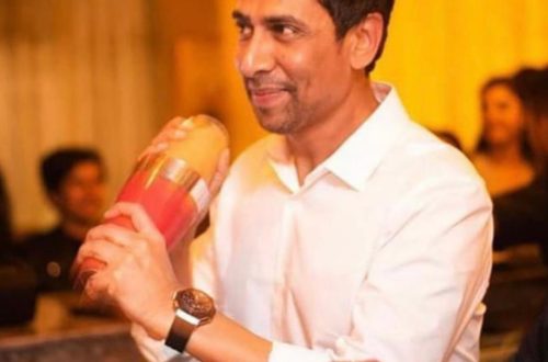 A man in a white shirt, mid-side-eye. Symbolic of dry wit, sharp comebacks, and Bangalore sarcasm at its finest.