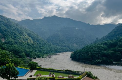 Laying down emotional weight by a calm mountain stream, finding peace and renewal in nature