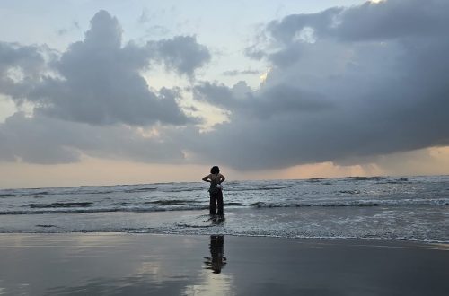 Sunrise over the ocean with gentle ripples reflecting soft light, evoking calm and reflection.