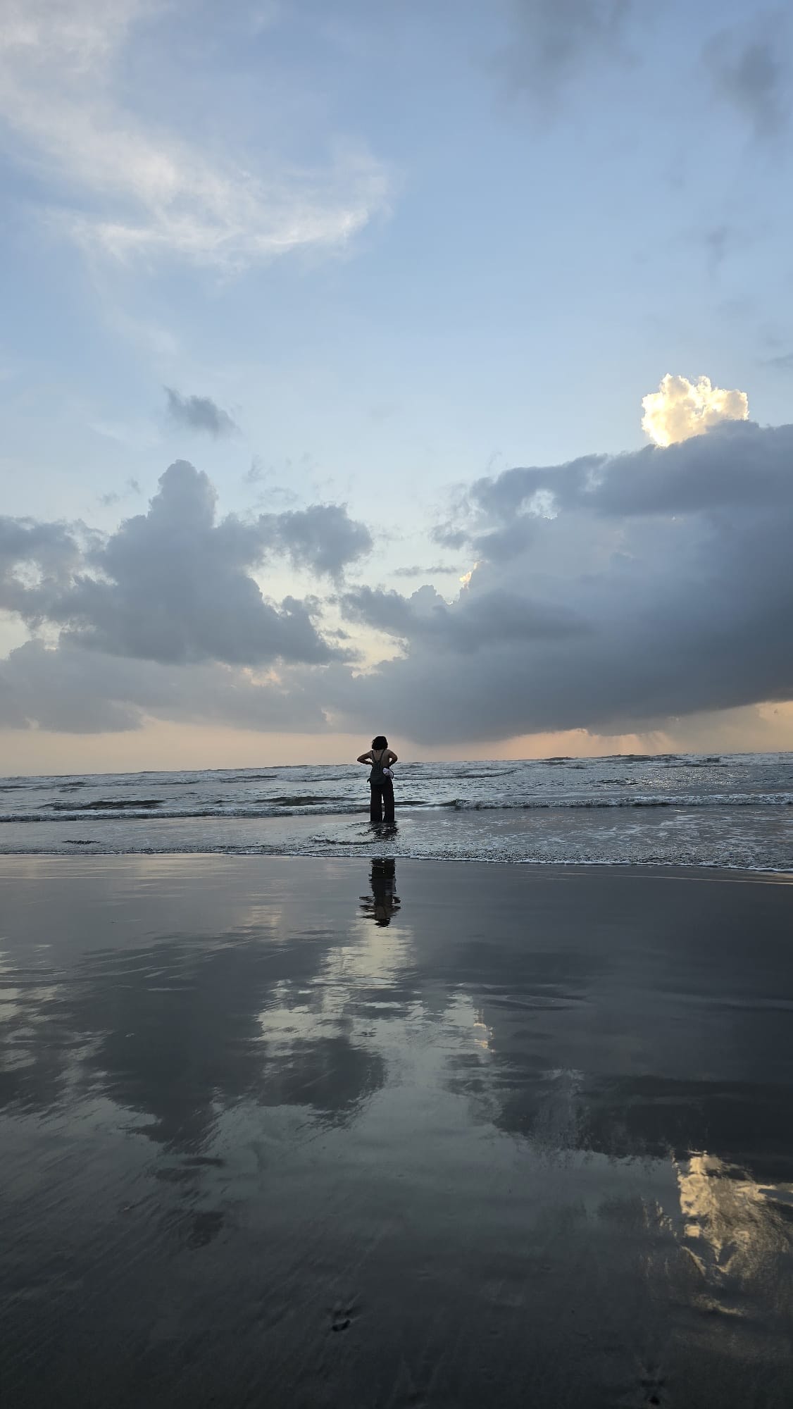 Sunrise over the ocean with gentle ripples reflecting soft light, evoking calm and reflection.
