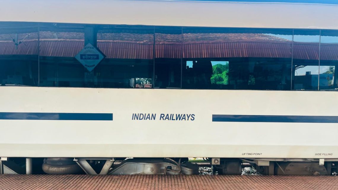 Person on a crowded Indian Railways platform, wearing sunglasses, looking anxious and overwhelmed by germs and chaos.”