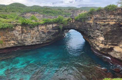 Cave bay in Vietnam with still water and rock walls opening into light, reflecting quiet isolation and depth.