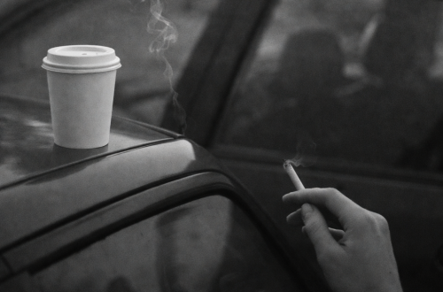 coffee and cigarette on a car roof symbolizing someone being invited and then ghosted
